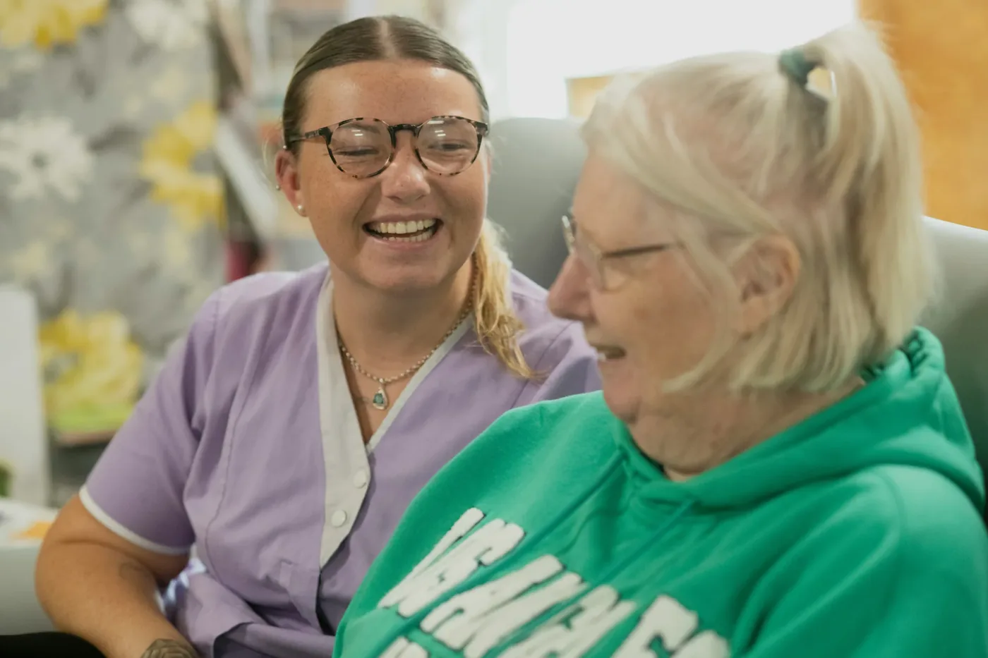 A Hertz2Hearts facilitator sharing a warm one-to-one moment with a resident