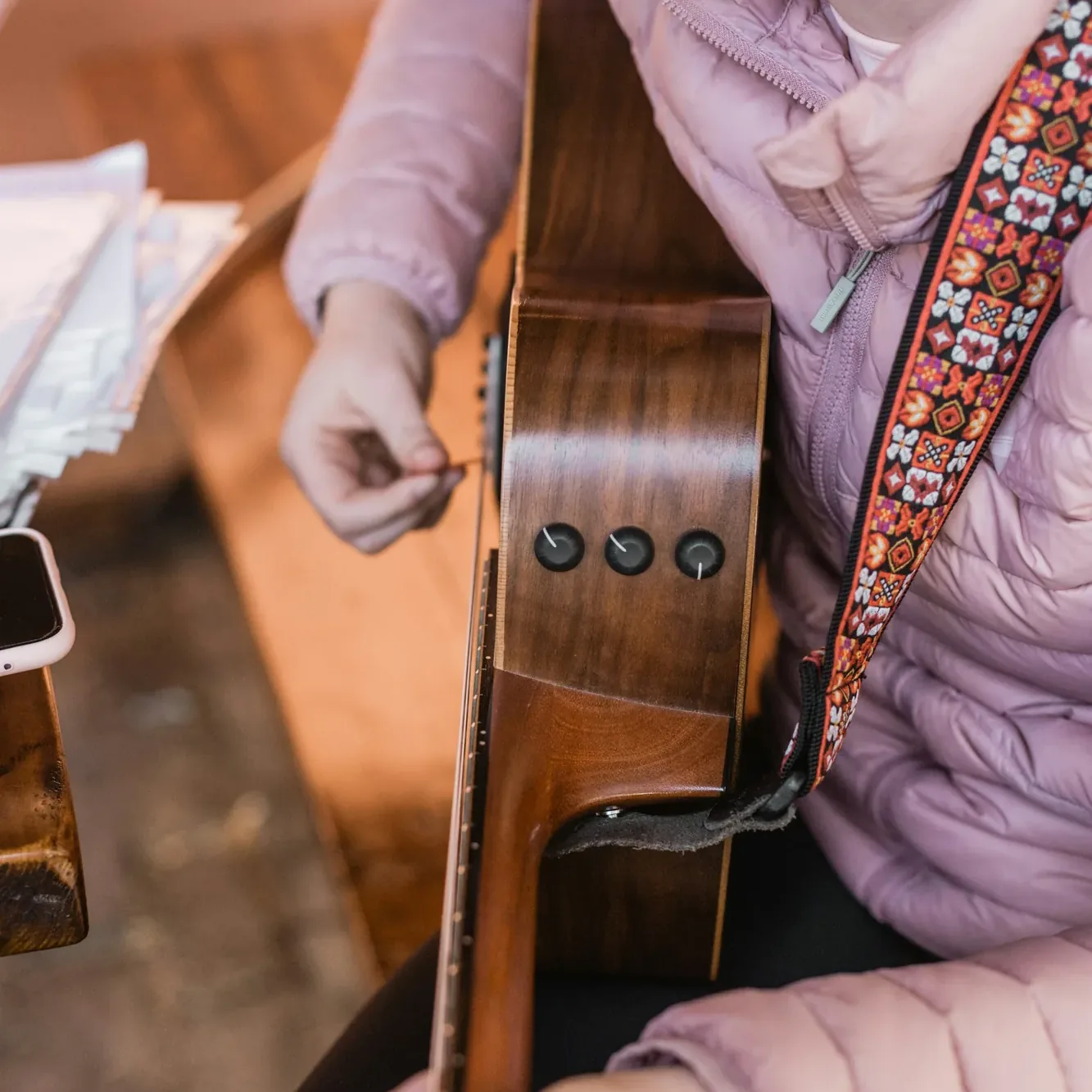 A resident joining in on guitar during a music session
