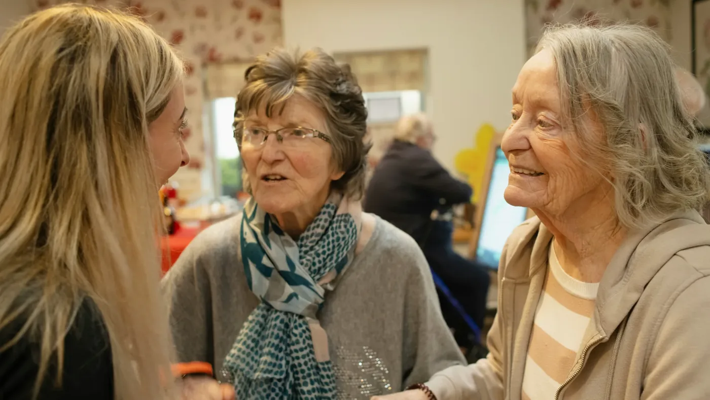 A facilitator gently engaging residents during a dementia-friendly music session