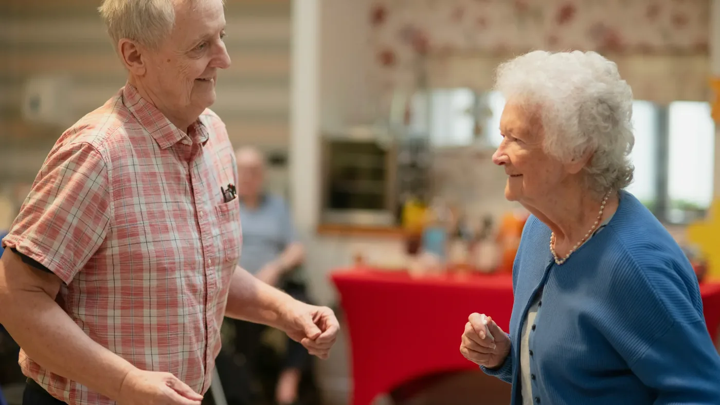 Residents on their feet, singing and dancing together during a live music session