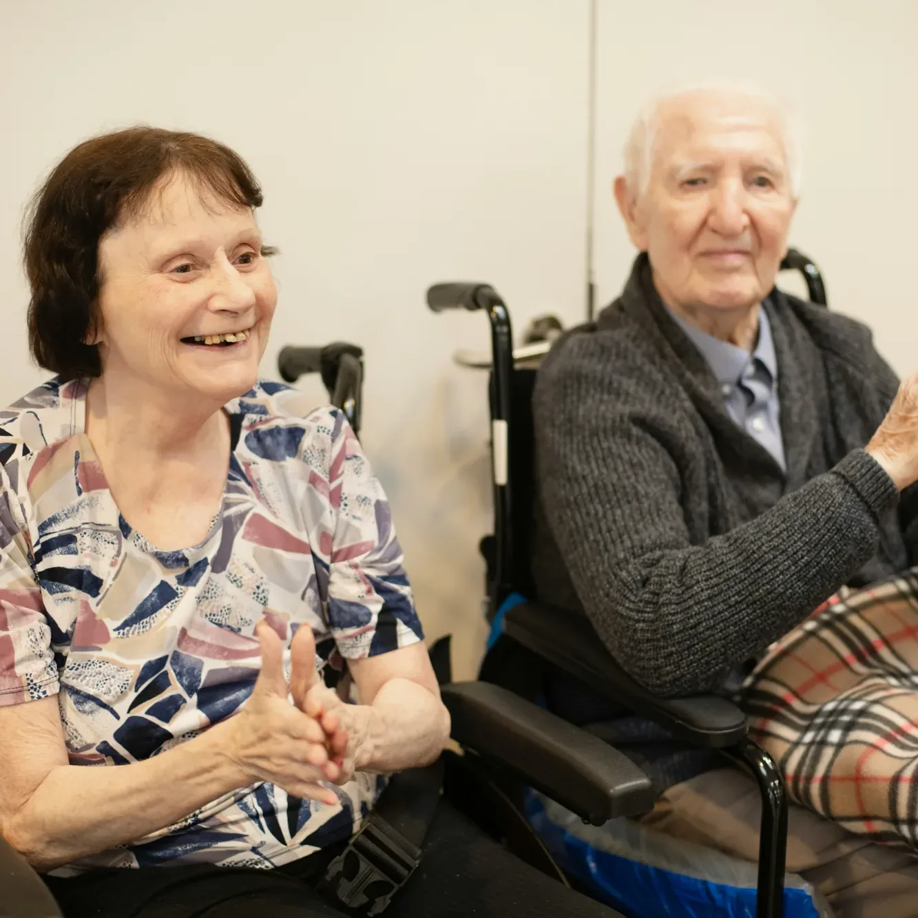 Two residents laughing together during a group music session