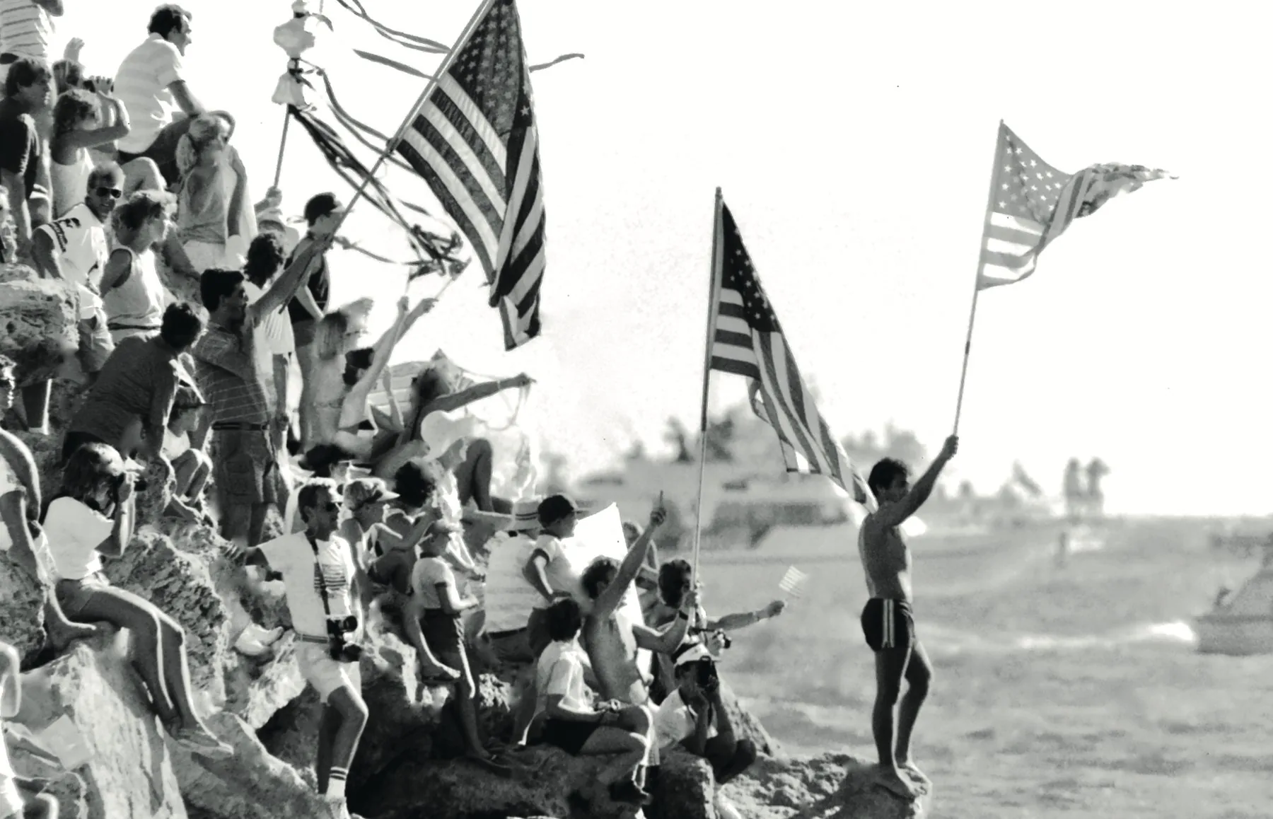 American fans waving flags as Stars and Stripes returns to its Fremantle mooring, 1987, black and white